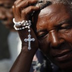 A woman holds a rosary as she takes part on a wedding ceremony in front of the destroyed national cathedral in downtown Port-au-Prince, Sunday, Feb. 28, 2010. A magnitude-7 earthquake struck Haiti last Jan. 12. A 7.0-magnitude earthquake struck Haiti last Jan. 12, destroying great part of the capital's infrastructure. 

(AP Photo/Esteban Felix)