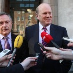 Minister for Public Expenditure and Reform Brendan Howlin looks pensive as Finance Minister Michael Noonan reports on their talks with IMF officials in Dublin on Wednesday. Pic:Niall Carson/PA Wire.
