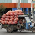 Vendors carry bags of onions on an extraordinary-looking modified truck to sell at a local bazaar in Mandalay in central Myanmar. (AP Photo/Khin Maung Win)