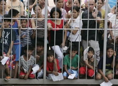 Boys accompanied by their parents queue for free circumcision surgery in Marikina today.