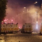 This photograph of police coming under fresh attacks in the Newtownards Road area of Belfast was taken by photographer Niall Carson shortly before he was shot in the leg.