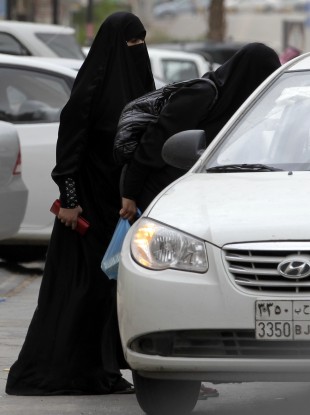 Saudi women board a taxi in Riyadh, Saudi Arabia