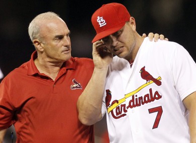 St Louis Cardinals trainer Barry Weinberg helps Cardinals left fielder Matt Holliday.