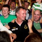 Manager Michael O'Neill is surrounded by fans at the airport.