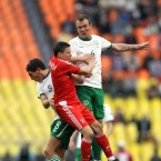 Ireland's Glenn Whelan jumps with Igor Semshov of Russia.
