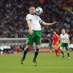 Robbie Keane controls a high ball.