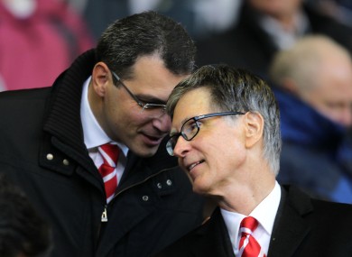 Comolli, left, talks to Liverpool's principal owner John Henry.