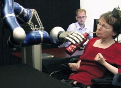 Hutchinson controlling the arm to bring coffee to her mouth