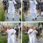 Handout photo issued by LOCOG of Torchbearer 131 Sir Bruce Forsyth carries the Olympic Flame on the Torch Relay leg through Kensington and Chelsea (Royal London Borough).PRESS ASSOCIATION Photo. Picture date: Thursday July 26, 2012. See PA story OLYMPICS Torch. Photo credit should read: Ben Birchall/PA Wire