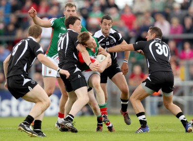 Sligo's Eugene Mullen, David Maye and Eamonn O'Hara tackle Donal Vaughan of Mayo