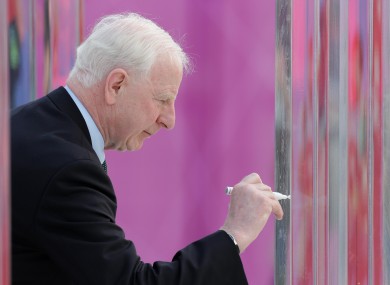Hickey signing the peace wall in London's Olympic village yesterday.