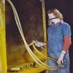 Elizabeth Little, mother of two, is seen spraying small parts for the US Army Air Corps in Milwaukee, Wisconsin.