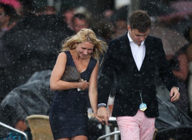 Racegoers dash for cover on Ladies Day at York's Ebor Festival.