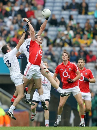 Cork's Graham Canty competes with John Doyle (L) and Michael Foley of Kildare for a high ball