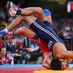 Scott Coleman from USA (red) in action against Asgarov Toghrul of Azerbaijan in their Men's Freestyle Wrestling 60kg Semi Final  at the Excel Arena, London.