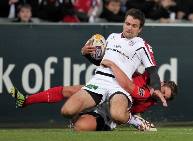 Jared Payne of Ulster is tackled by Munster's Ian Keatley.