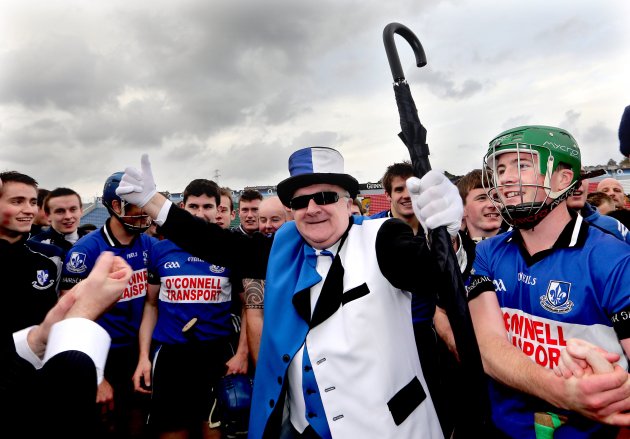 A colourful Sarsfields fan celebrates with the team after the game 7/10/2012