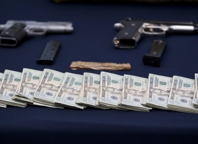 Mexican police display guns and cash seized from the Zetas drug cartel in previous raids.