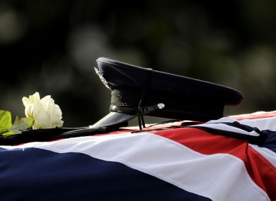 The hat and gloves of murdered prison officer David Black are placed on his coffin during his funeral service at Molesworth Presbyterian Chuch in Cookstown, Northern Ireland