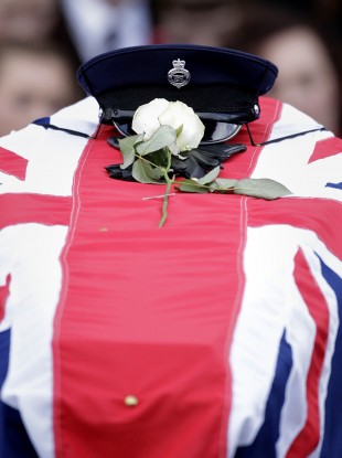 The hat and gloves of murdered prison officer David Black rests on his coffin