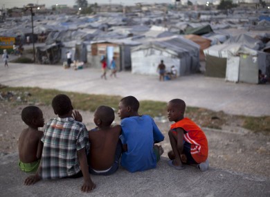 A group of boys look across Jean Marie Vincent camp in Port-au-Prince, Haiti, on Wednesday where they now live.