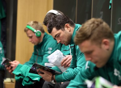 Rob Kearney reads a match programme before Ireland v France.