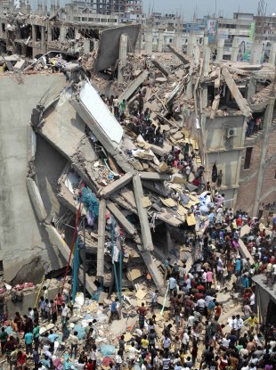 People and rescuers gather after an eight-story building housing several garment factories collapsed in Savar, near Dhaka, Bangladesh, today.