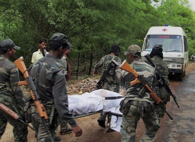 Indian security personnel carry the body of one of the victims of the Maoist attack in a densely forested area in Bastar.