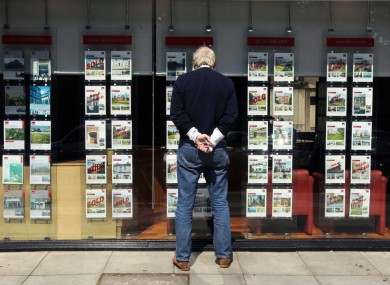 A man looks through the window of an estate agent in Dublin city