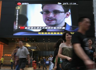 A TV screen shows a Chinese news report of Edward Snowden.