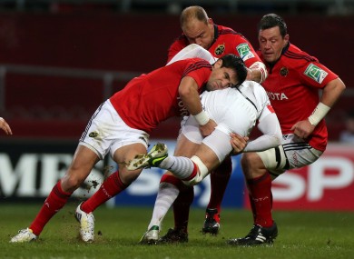 Conor Murray tackles Alex Goode at Thomond Park last December.