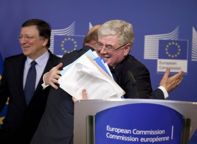 Tánaiste Eamon Gilmore hugs Martin Shultz, the president of the European Parliament, after the budget was agreed