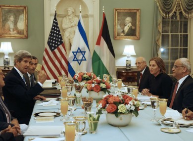 US diplomat John Kerry (left) with Palestinian and Israeli negotiators at dinner last night