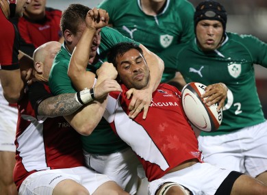 Canadian scrumhalf Phil Mack is grappled by Tommy O'Donnell.
