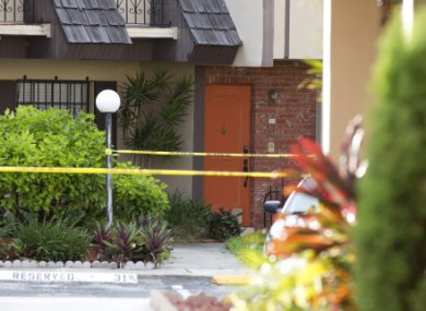 Police tape blocks the entrance to a murder scene in Miami