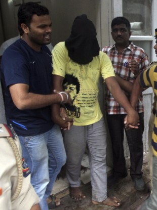 Police officials escort the fifth man accused of the gang rape in Mumbai earlier today.
