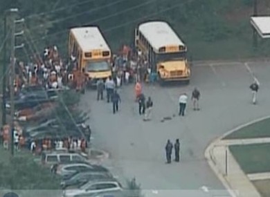 Children assemble outside the school after being evacuated from the building