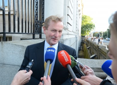 Taoiseach Enda Kenny talks to the media on his way into a cabinet meeting at Government Buildings. (File photo)