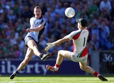 Ciaran Kilkenny of Dublin has a shot saved by Mayo goalkeeper Robert Hennelly.