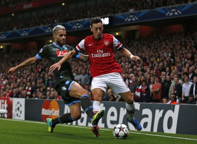 Özil is challenged by Napoli's Valon Behrami.