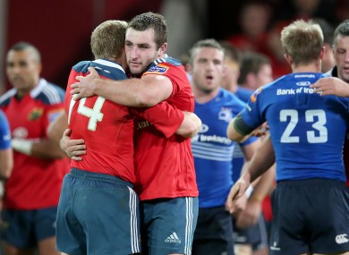 Replacement Munster prop James Cronin celebrates with try-scorer Keith Earls.