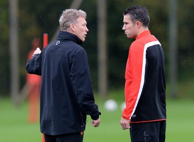 David Moyes speaks to Robin van Persie in training yesterday.