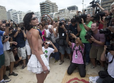 A woman poses for photos during a protest against a topless ban on the Ipanema beach in Rio yesterday.